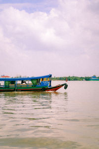 Boat moored in sea against sky