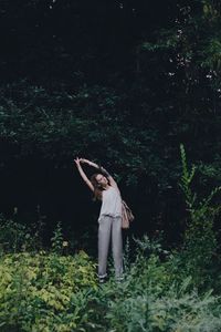 Woman with umbrella standing on field