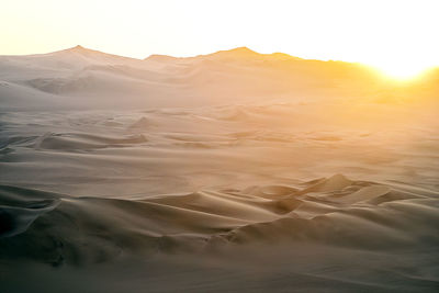 Scenic view of desert against sky during sunset
