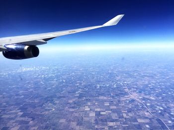 Cropped image of airplane flying over landscape