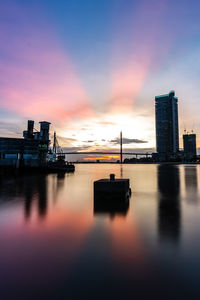 Bridge over river against sky during sunset