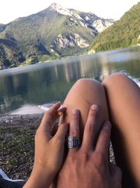 Close-up of hand with water in lake