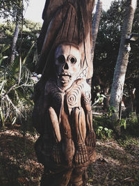 Statue of tree trunk in forest