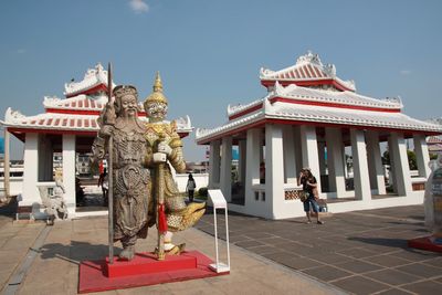 Statue of temple against building