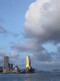 Sea by buildings against sky