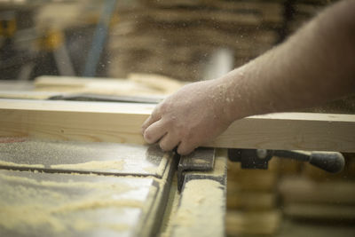 Cropped hand of man working at workshop