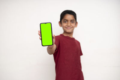 Portrait of smiling man standing against white background