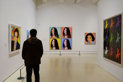 Man standing against wall in museum