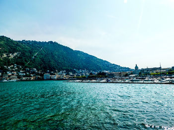 Scenic view of sea and buildings against sky