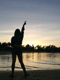 Full length of silhouette man on beach against sky during sunset