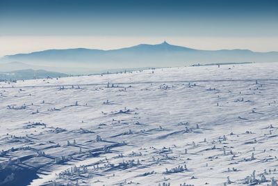 Scenic view of snow covered mountains against sky