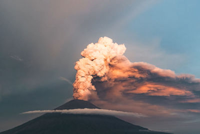 Smoke emitting from volcanic mountain against sky