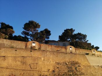 Low angle view of built structure against clear blue sky