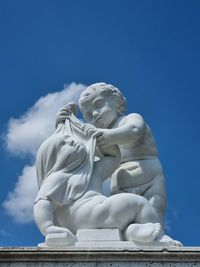 Low angle view of statue against clear blue sky