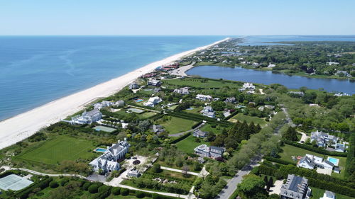 High angle view of townscape by sea against sky