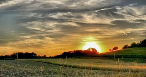 Scenic view of field against sky during sunset