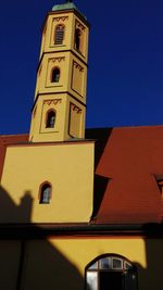 Low angle view of bell tower against sky