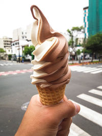 Close-up of hand holding ice cream cone