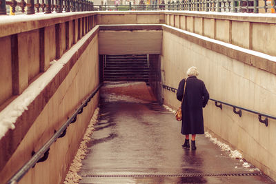 Full length of woman standing in front of building