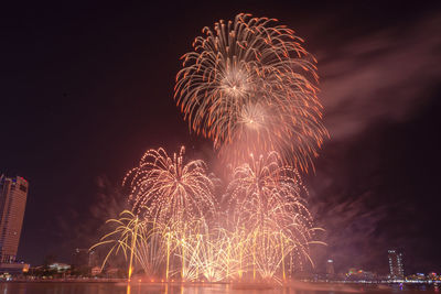 Low angle view of firework display at night