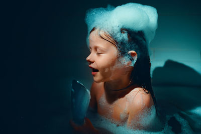 Portrait of young woman swimming in sea