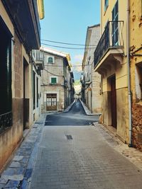 Empty alley amidst buildings in city