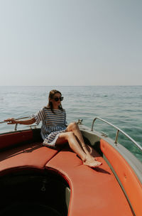 Portrait of a young beautiful girl sitting in a boat.