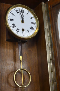 Low angle view of clock on wooden table