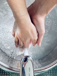 Close-up of person washing hands