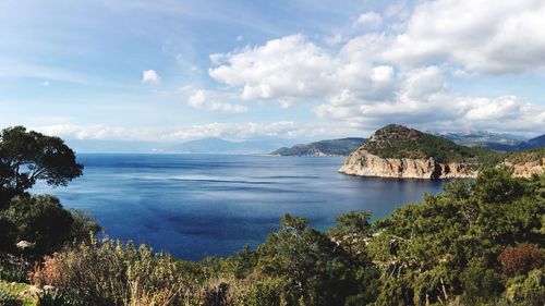 Scenic view of sea and mountains against sky