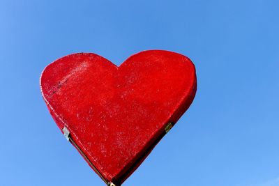 Low angle view of heart shape against blue sky