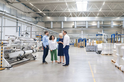 Businessmen and businesswomen discussing with each other in industry