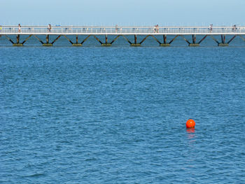 Scenic view of bridge over sea against sky