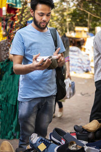 Man choosing shoes in market