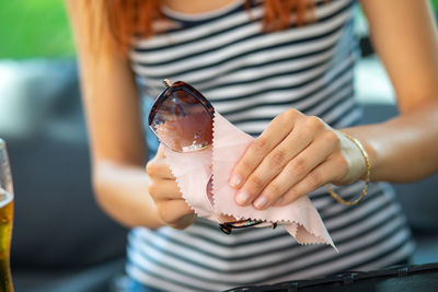 Midsection of woman holding ice cream