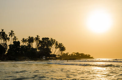 Scenic view of sea against clear sky at sunset