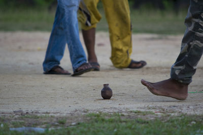 Low section of boys spinning top at playground