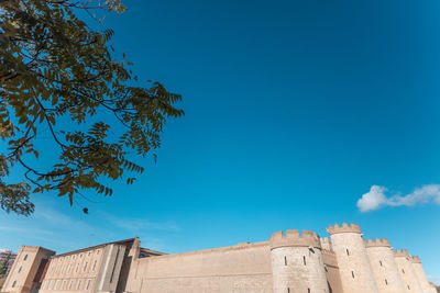 Low angle view of historic building against blue sky