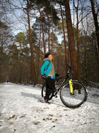 Woman on bicycle in forest