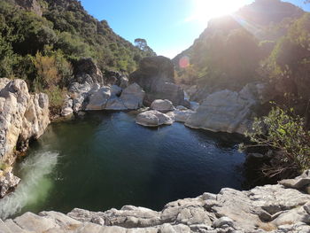 Scenic view of waterfall against sky