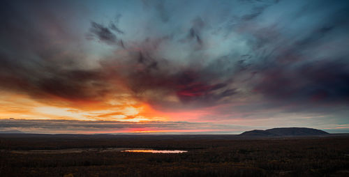 Scenic view of dramatic sky over land