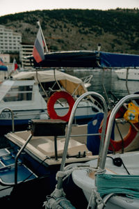 Close-up of sailboats moored at harbor
