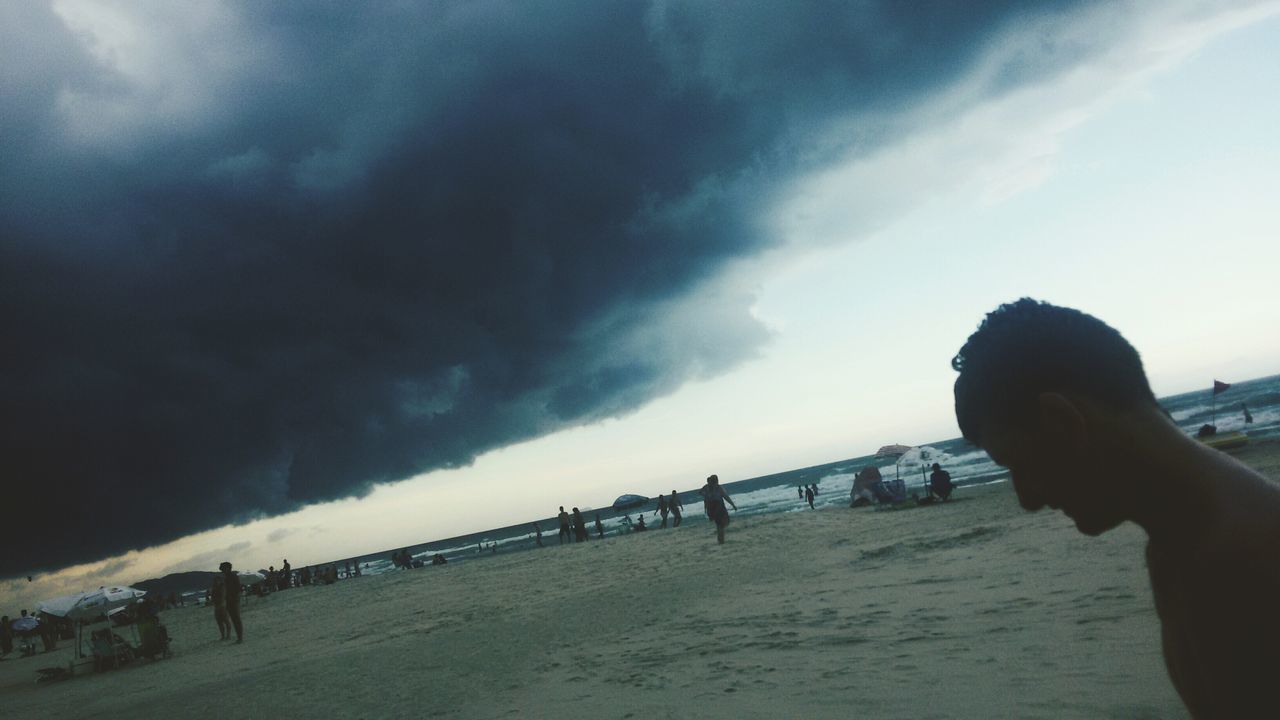 sky, water, cloud - sky, sea, lifestyles, cloudy, leisure activity, built structure, architecture, person, beach, cloud, men, unrecognizable person, weather, nature, outdoors, day