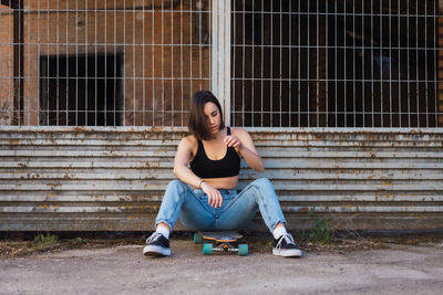 Portrait of young woman sitting outdoors