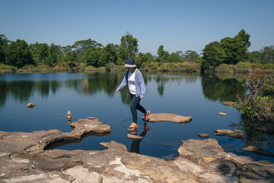 Rear view of man standing in lake