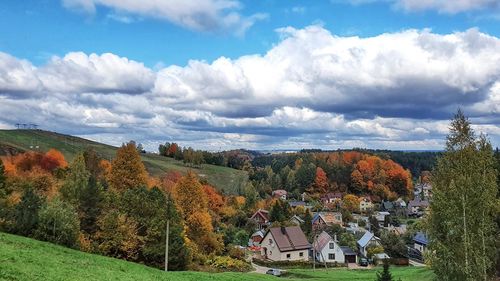 Panoramic view of trees and houses against sky during autumn