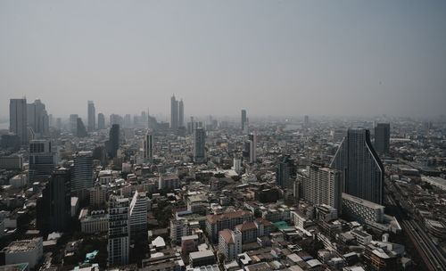 High angle view of modern buildings in city against clear sky