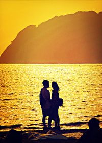 Silhouette of man looking at sea