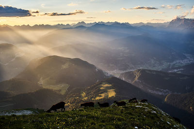 Scenic view of mountain range against sky during sunset