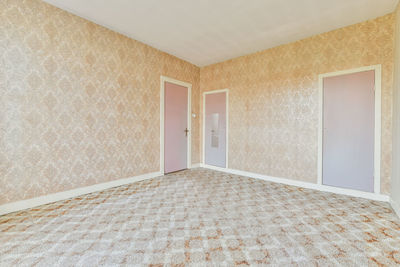 Wallpapered walls in empty room